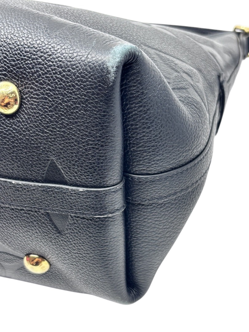 Posh Purse Co black Louis Vuitton CarryAll handbag showing detail of the textured leather base and gold hardware