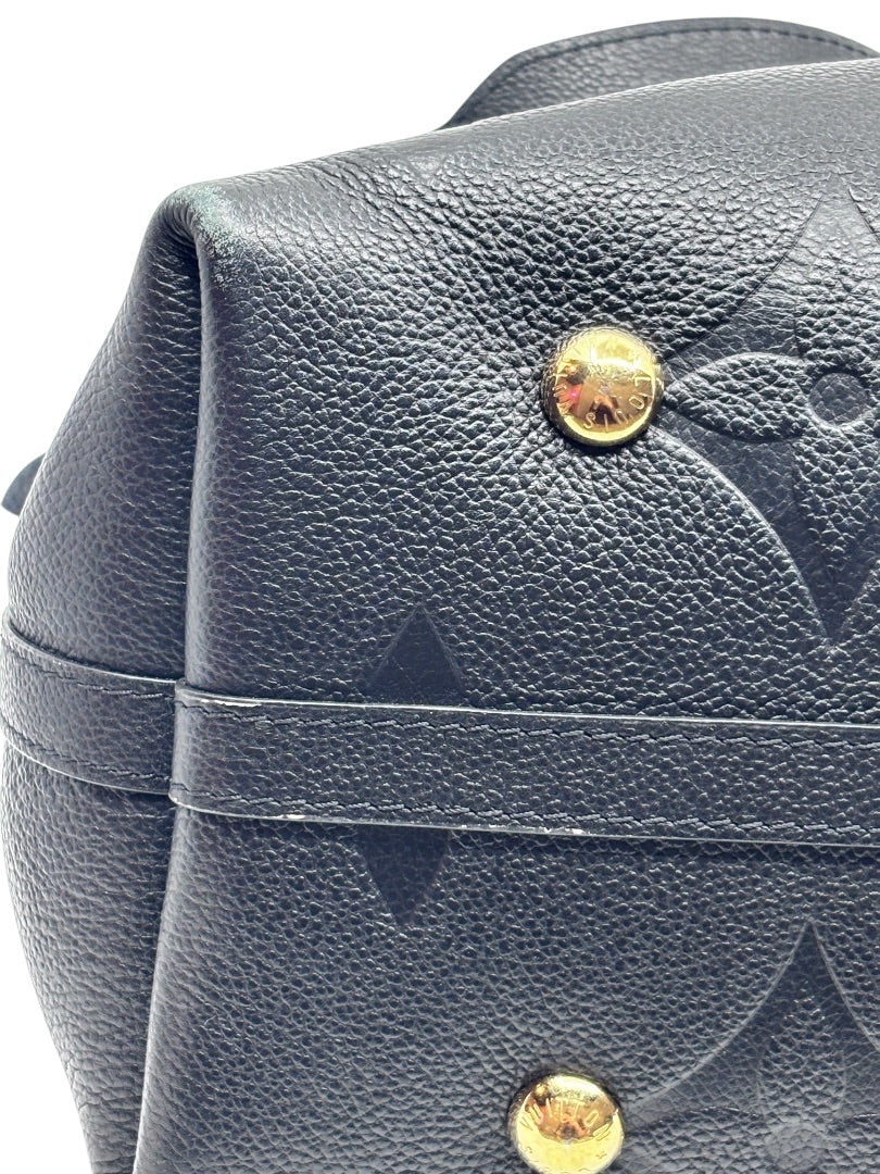 Posh Purse Co black Louis Vuitton CarryAll handbag showing textured leather, gold hardware studs, and corner detail.
