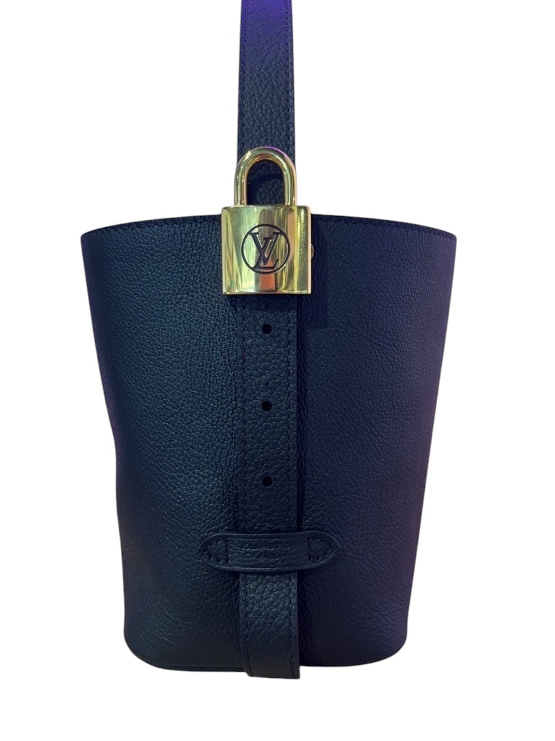 Posh Purse Co. black Louis Vuitton Lowkey Carryall bag featuring a gold padlock closure and grained leather texture.
