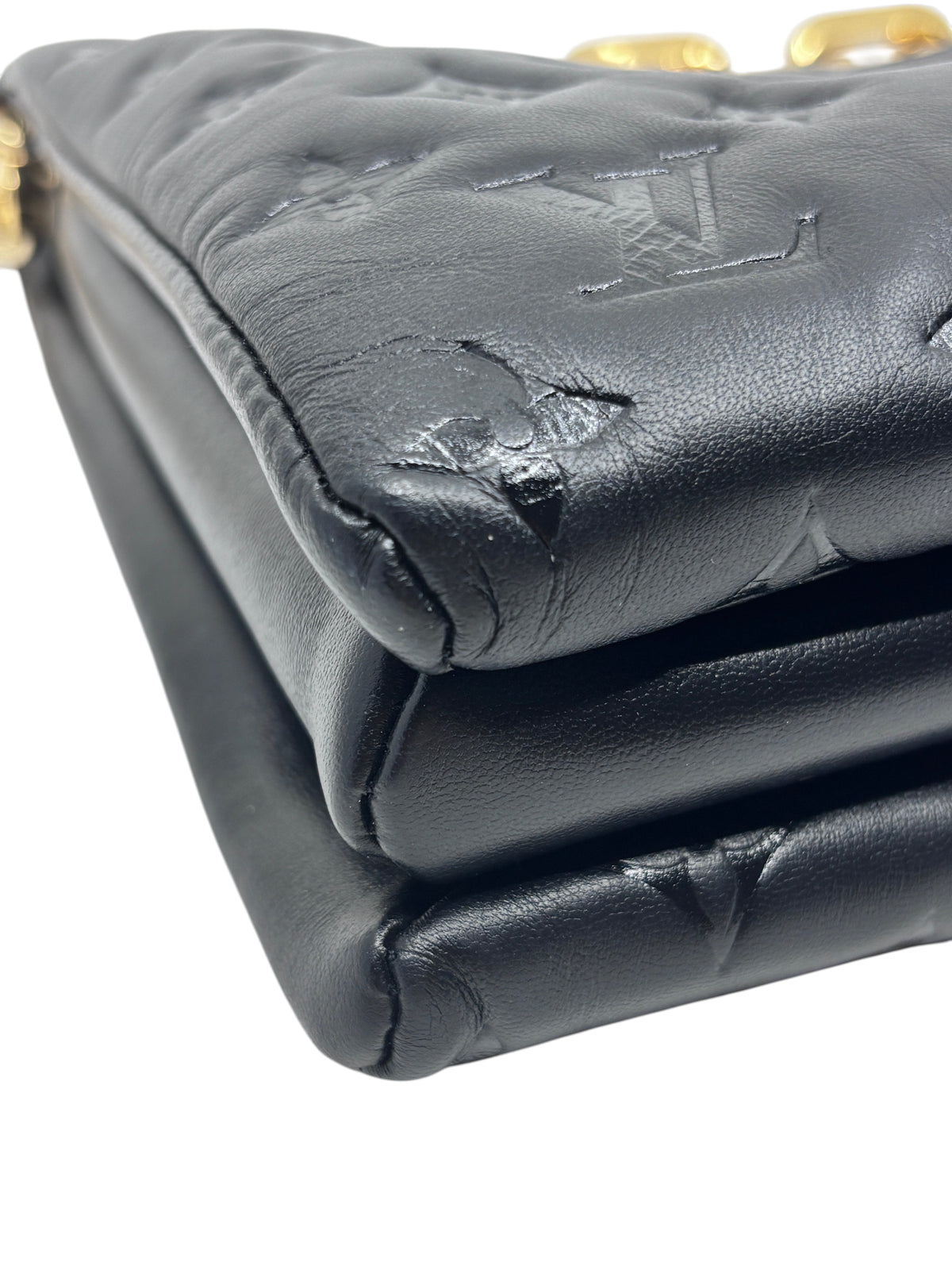 Posh Purse Co black Louis Vuitton Coussin bag showing detailed view of the soft leather and embossed monogram pattern