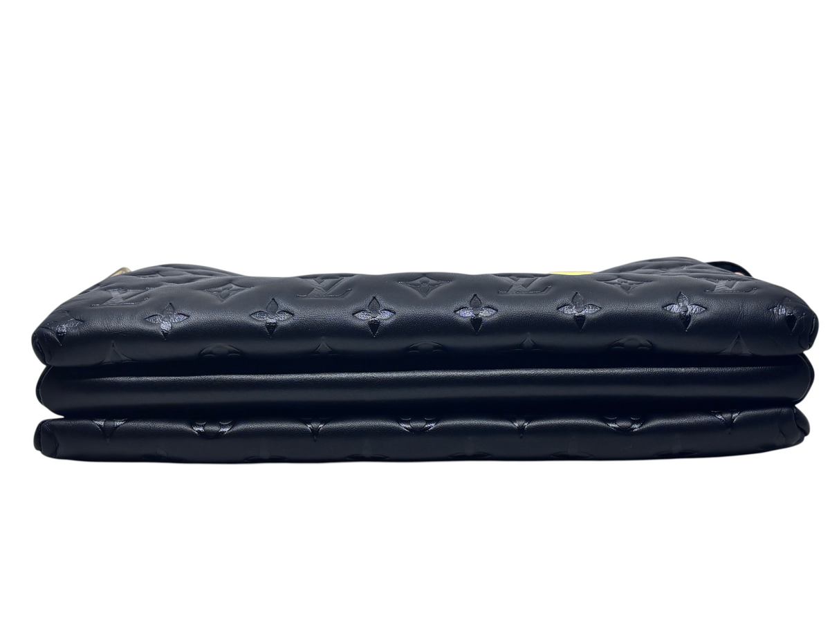 Posh Purse Co black Louis Vuitton Coussin bag with embossed monogram pattern, side view showing structured layers.