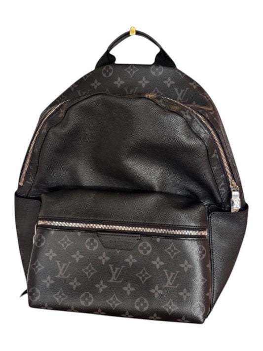 Posh Purse Co black Louis Vuitton Discovery backpack in coated canvas with leather trim and signature monogram pattern.
