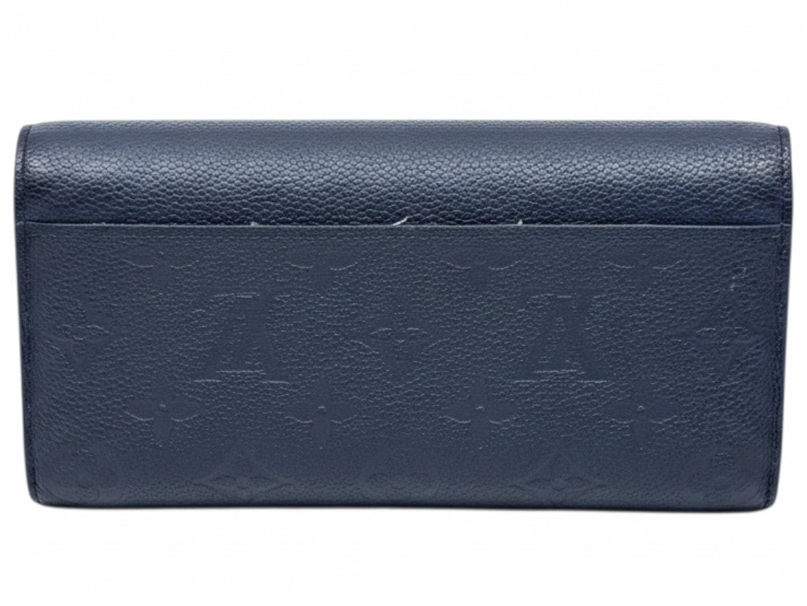Posh Purse Co black Louis Vuitton Empreinte Sarah wallet featuring embossed monogram leather and back slip pocket