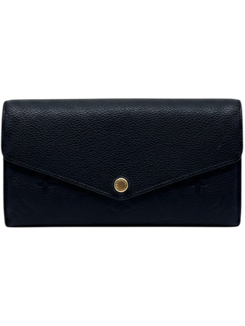 Posh Purse Co black Louis Vuitton Empreinte Sarah wallet with embossed monogram pattern and envelope flap closure