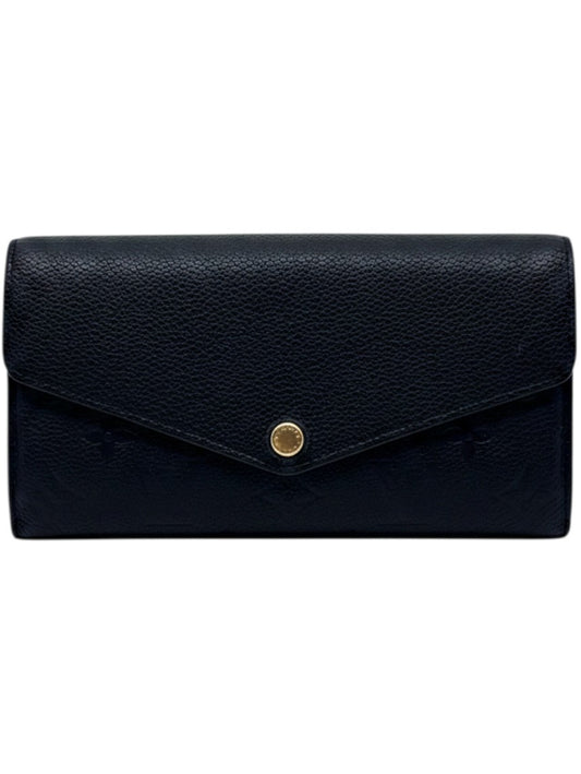 Posh Purse Co black Louis Vuitton Empreinte Sarah wallet with embossed monogram pattern and envelope flap closure