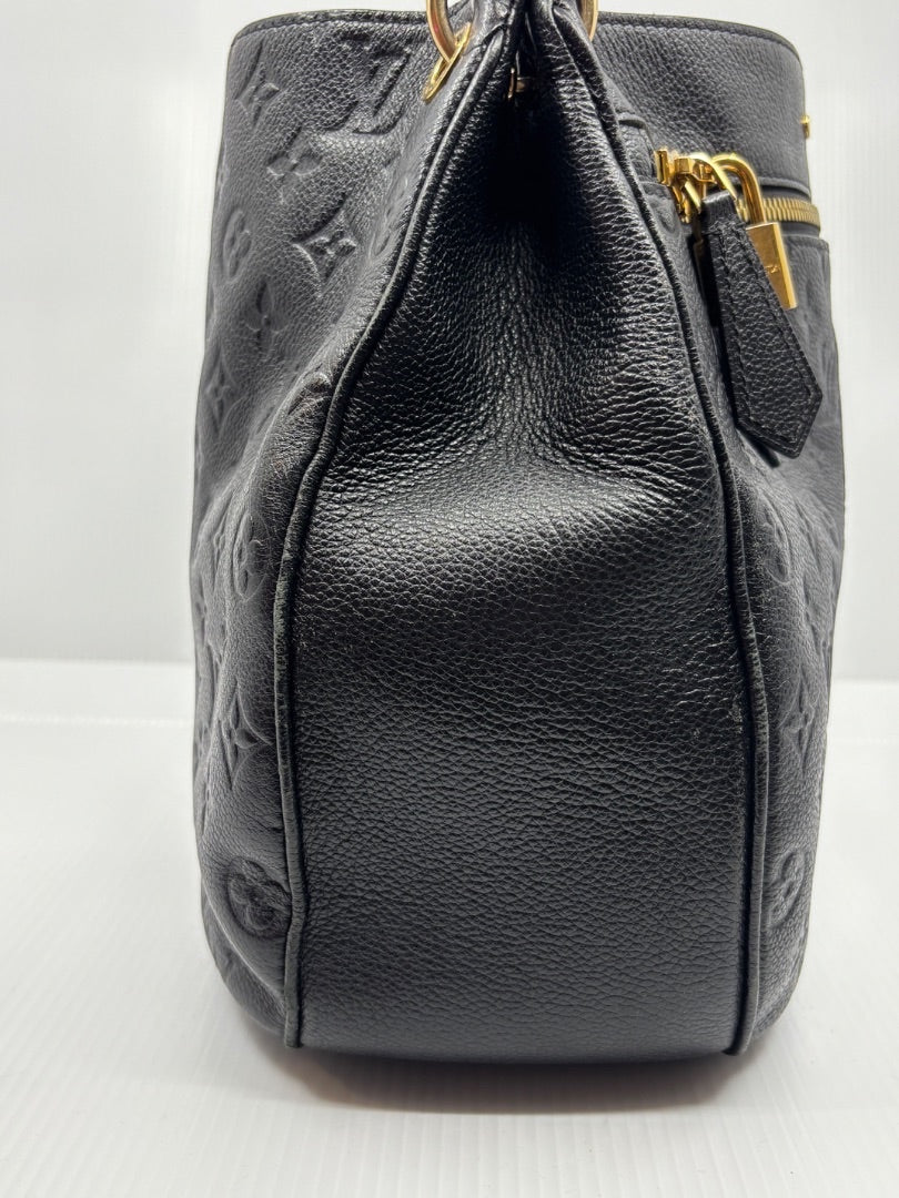 Posh Purse Co. black Louis Vuitton Empreinte Spontini handbag with embossed monogram leather and gold hardware.