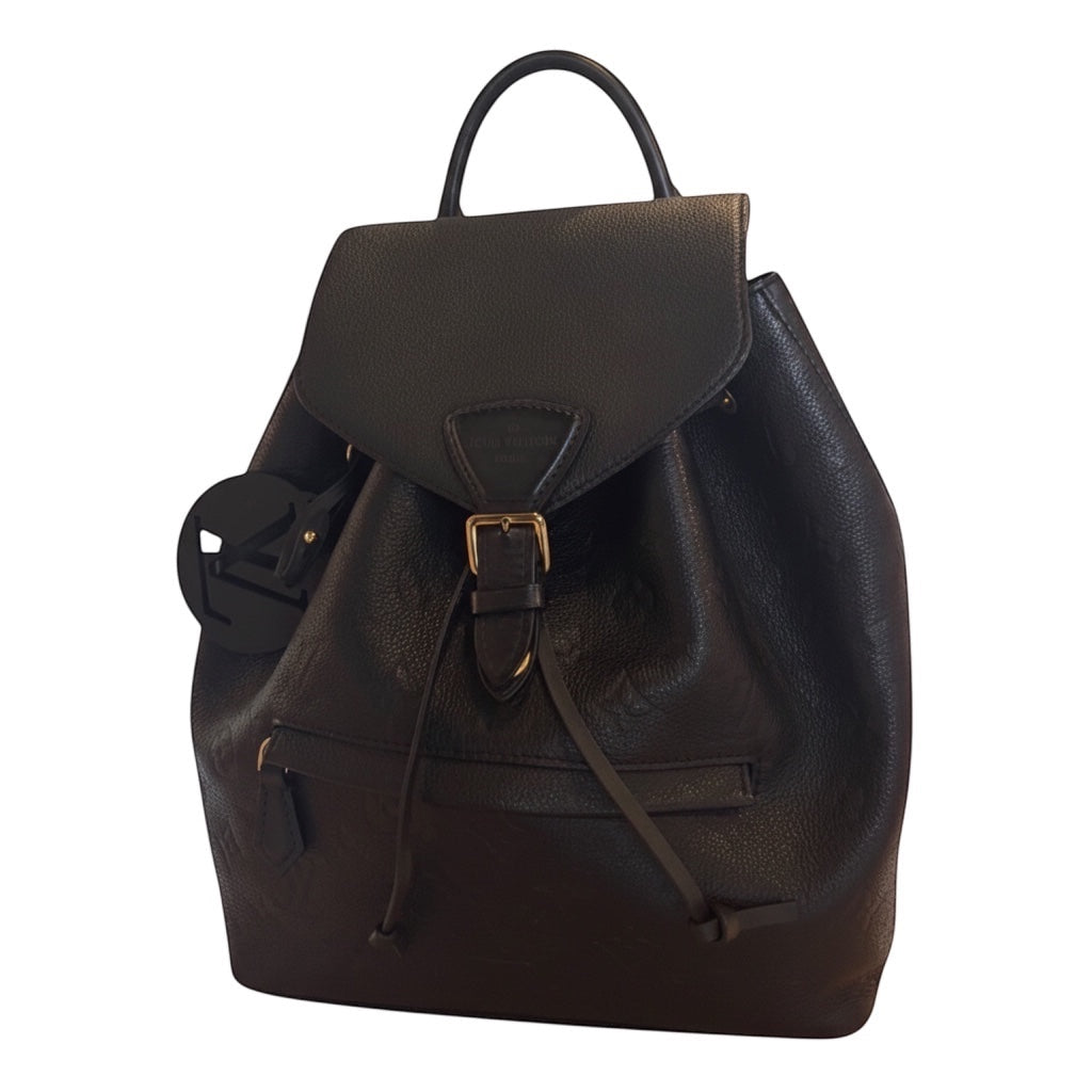 Posh Purse Co black Louis Vuitton Montsouris PM backpack in embossed leather with gold-tone hardware and drawstring closure.