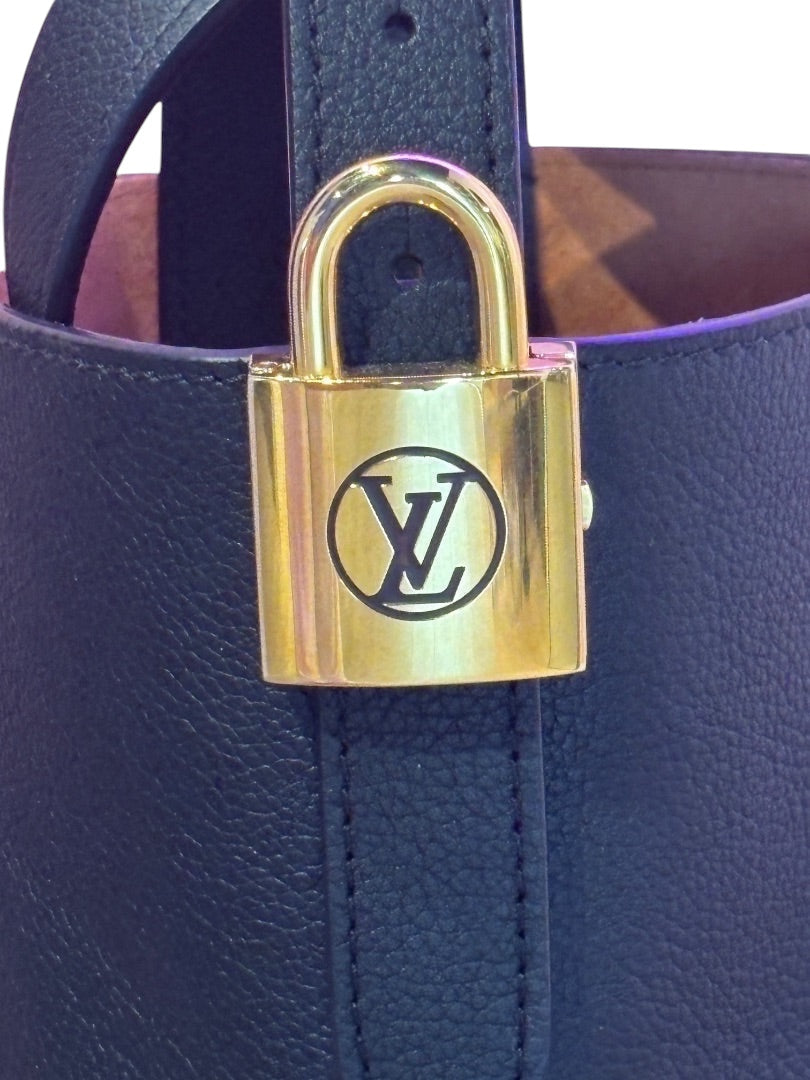 Posh Purse Co. black Louis Vuitton Lowkey Carryall featuring a polished gold-tone LV padlock detail on grained leather.