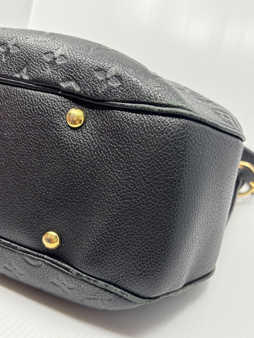 Posh Purse Co. black Louis Vuitton Empreinte Spontini handbag base with gold protective feet and embossed monogram.