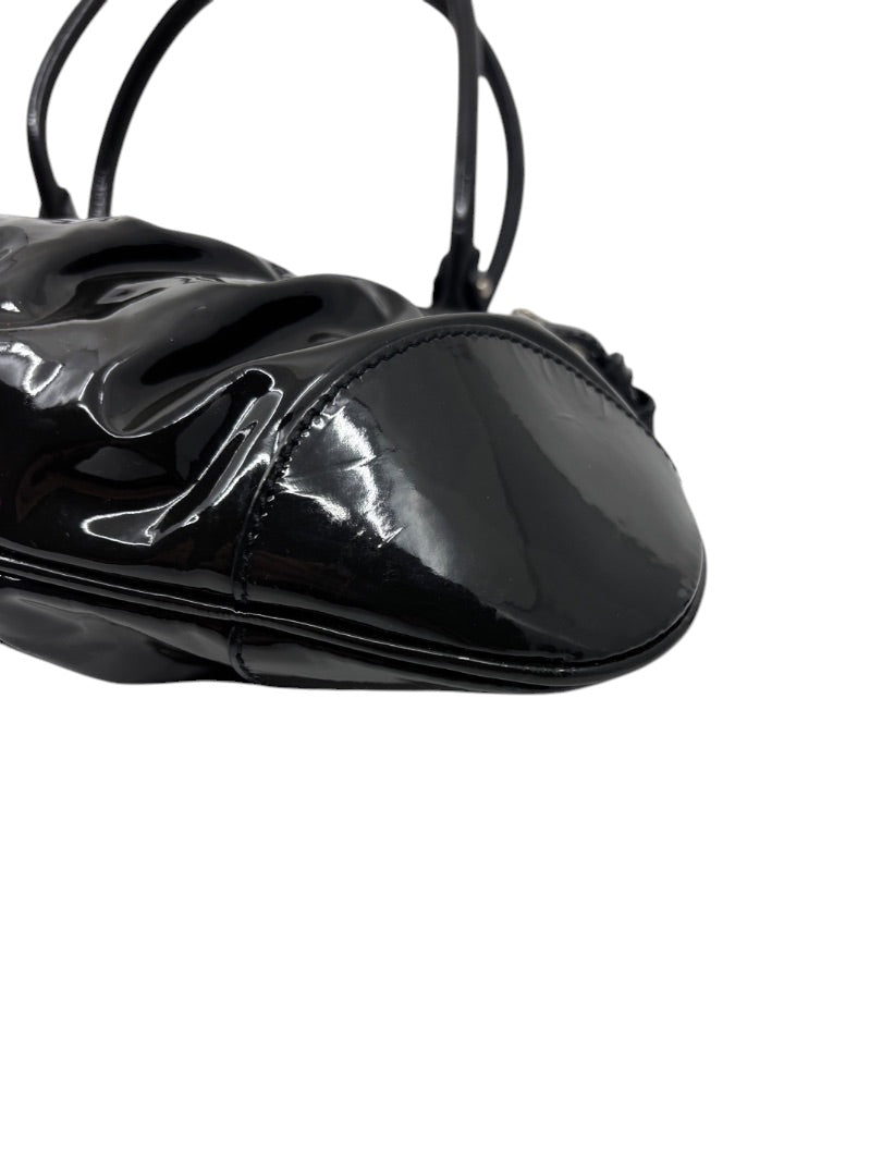 Posh Purse Co. black patent leather Ferragamo shoulder bag with a glossy finish and structured base detail.