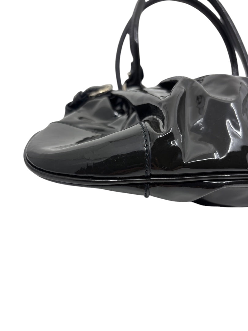 Posh Purse Co. black patent leather Ferragamo shoulder bag with a glossy finish and structured base detail.