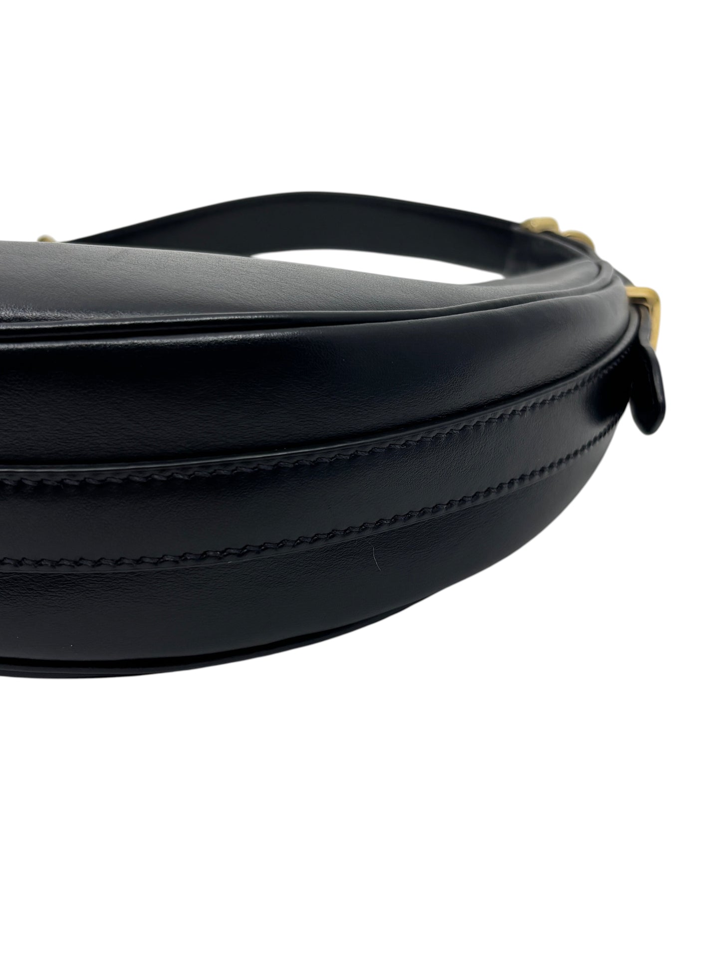 Posh Purse Co. black leather Prada Arqué shoulder bag showing curved silhouette and gold hardware detail.