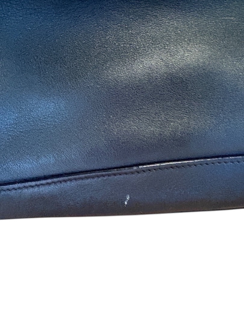 Posh Purse Co. black Prada leather bucket bag with subtle scuff mark on bottom edge.
