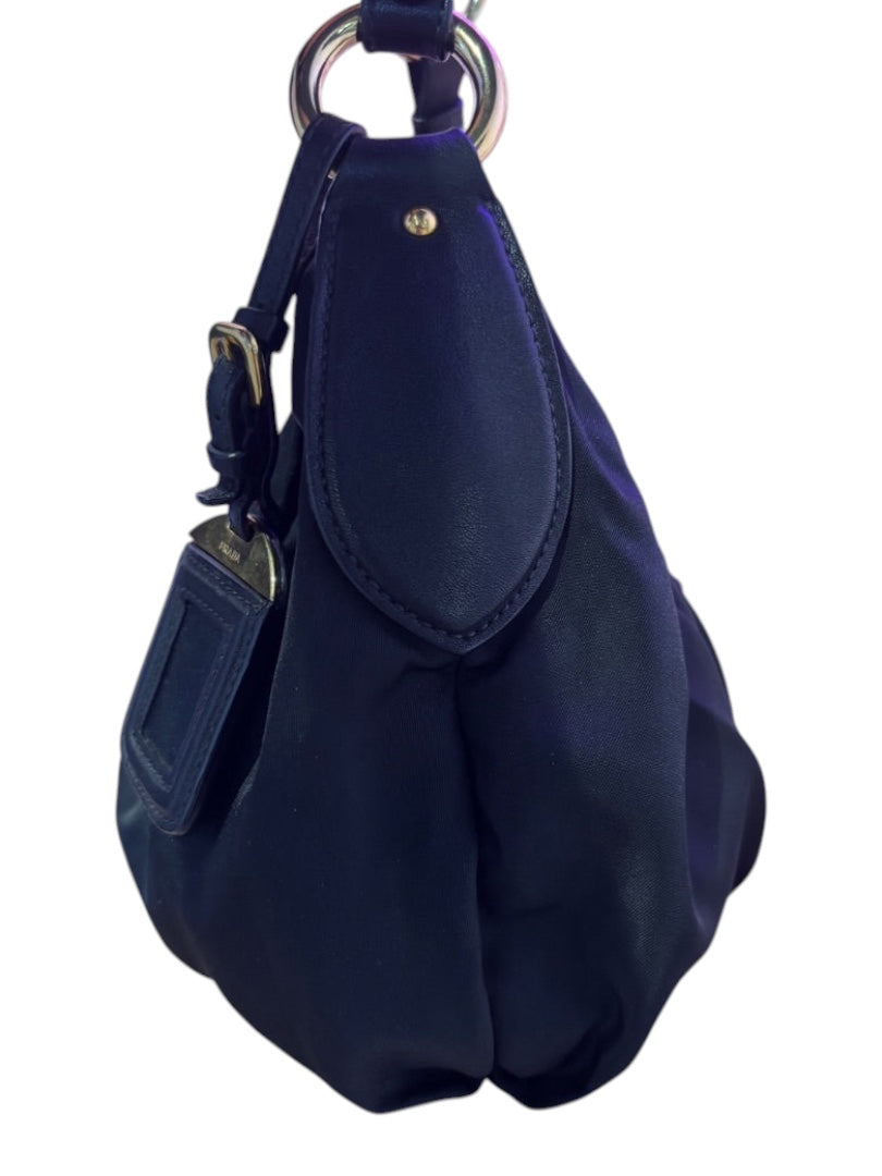 Posh Purse Co. black Prada nylon shoulder bag with gold hardware and leather trim, featuring a detachable leather tag.