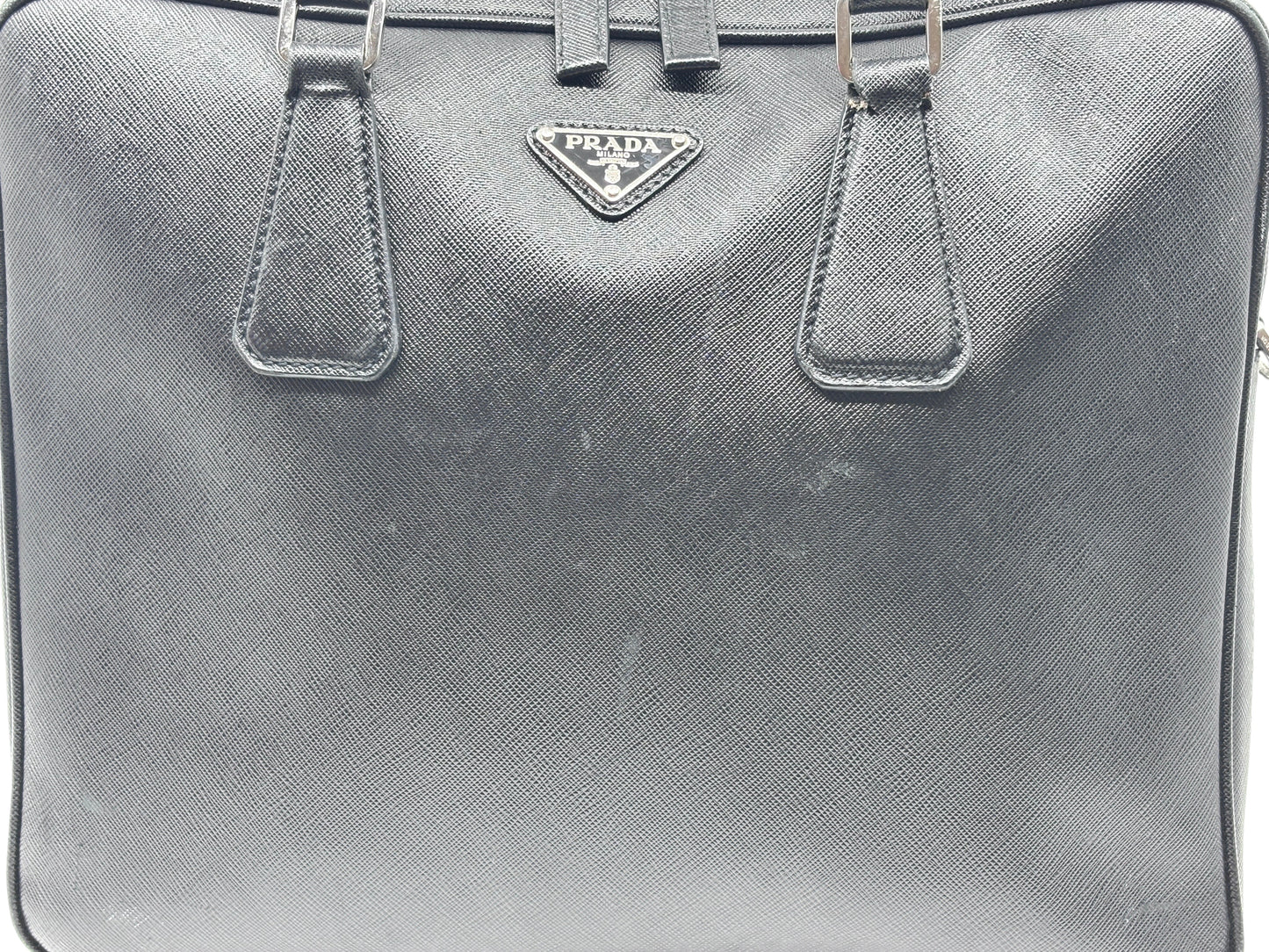 Posh Purse Co black Prada Saffiano leather briefcase with structured silhouette and signature logo plaque