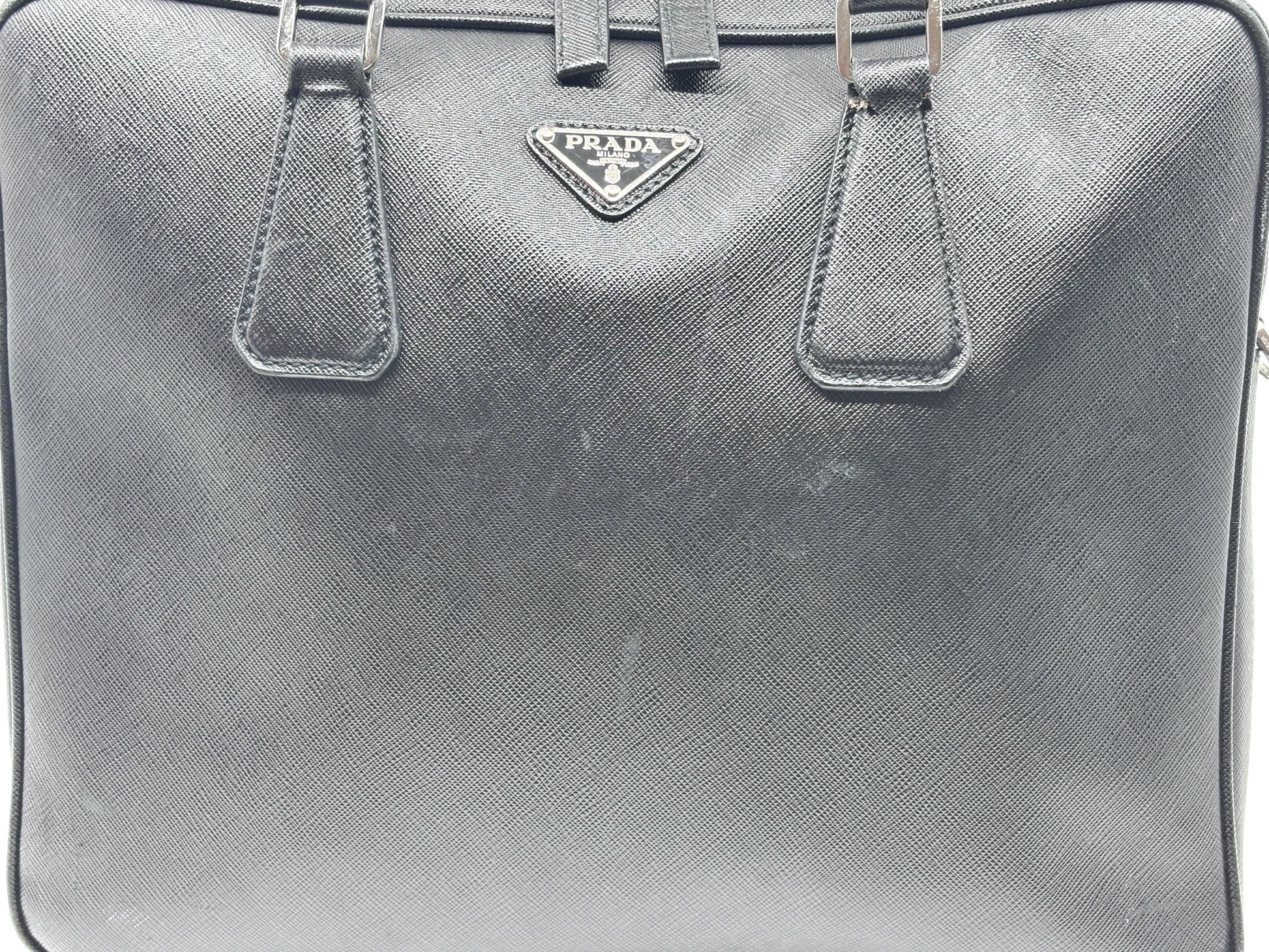 Posh Purse Co black Prada Saffiano leather briefcase with structured silhouette and signature logo plaque