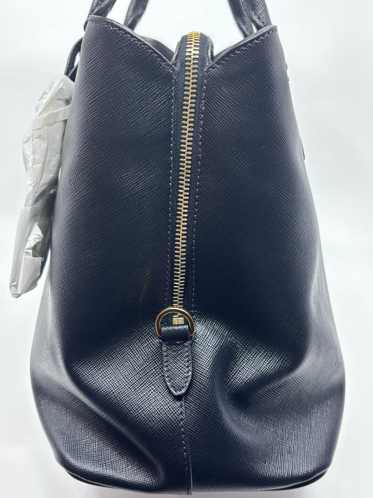 Posh Purse Co black Prada Saffiano leather tote bag side view with gold zipper detail and structured silhouette