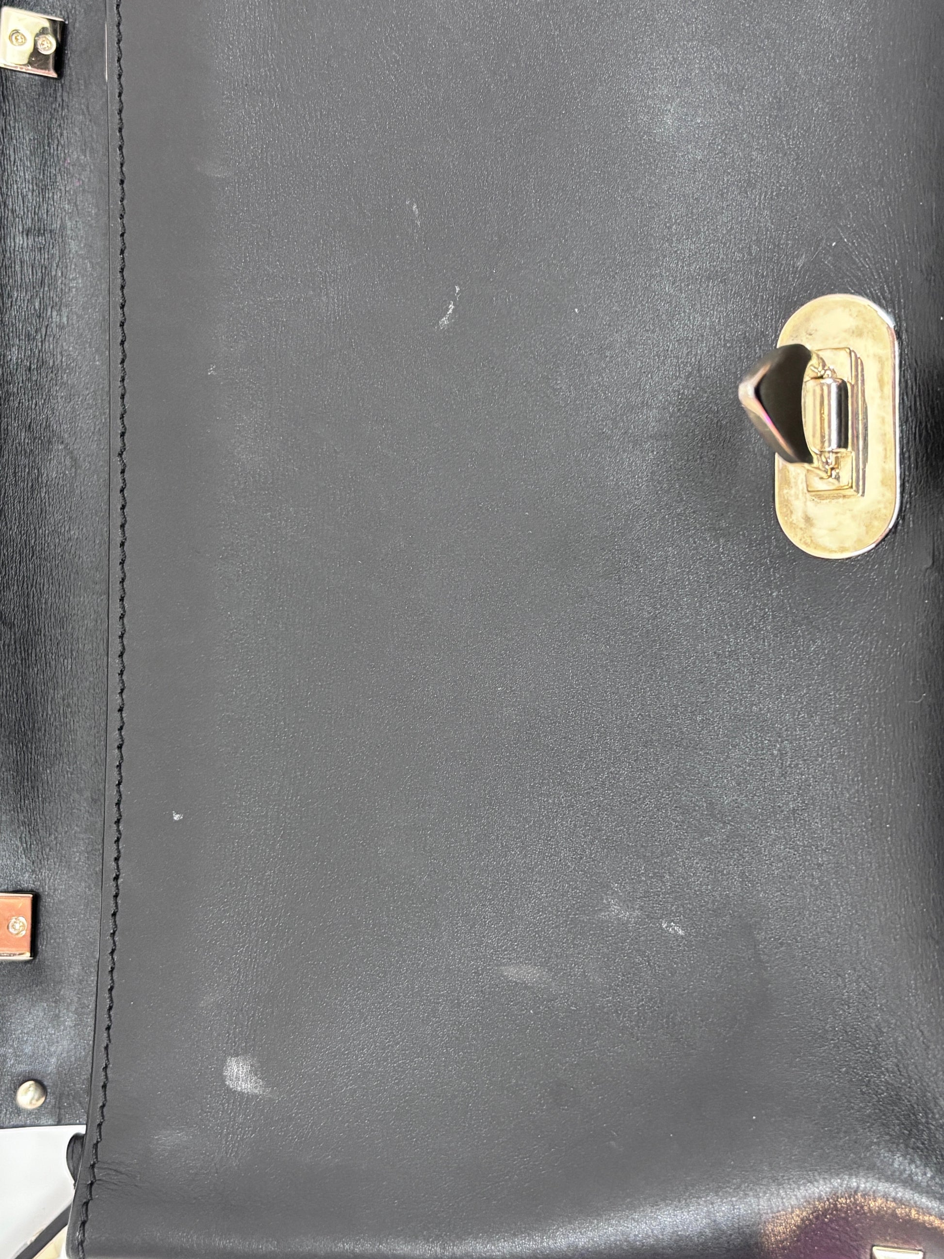Posh Purse Co. preloved black Valentino Rockstud flap bag featuring a gold flip-lock closure and leather texture.