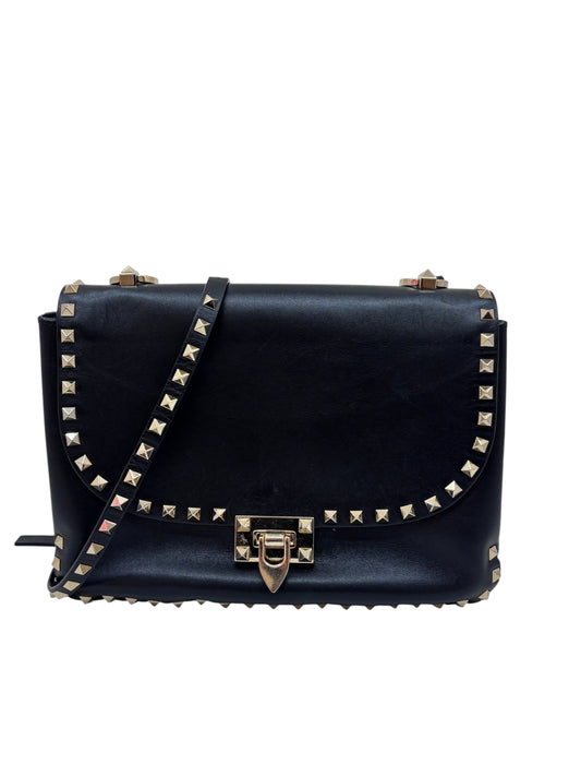 Posh Purse Co. black Valentino Rockstud flap bag with signature gold-tone pyramid studs and flip-lock closure.