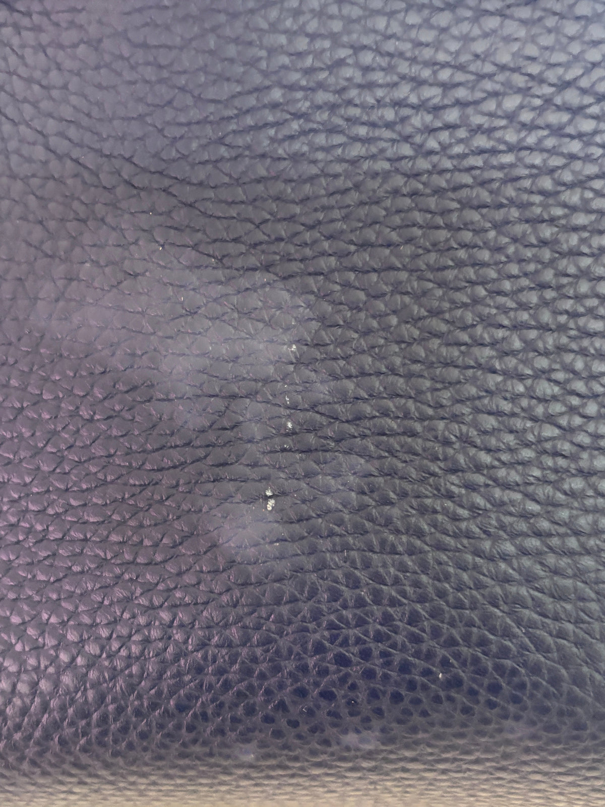 Close-up of blue textured leather on a Posh Purse Co. Fendi Selleria Peekaboo Mini bag showing surface wear and marks.