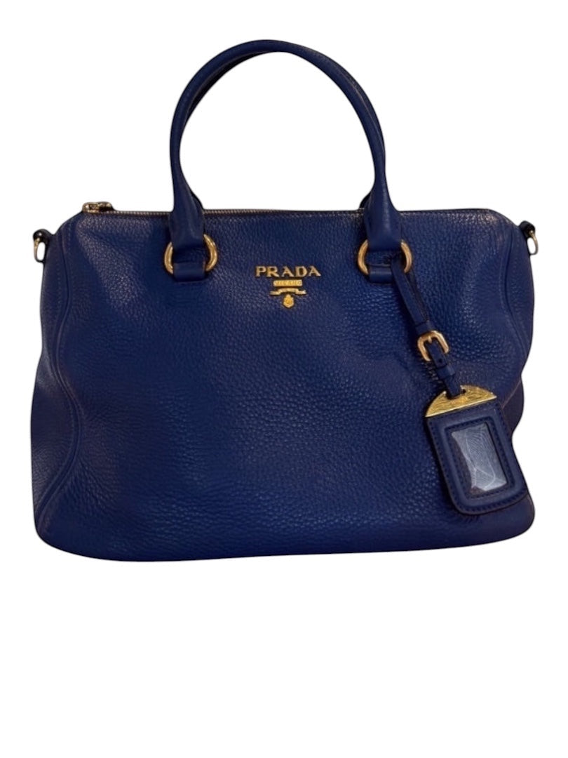 Posh Purse Co. blue Prada Vitello Daino leather handbag with gold hardware and iconic logo.