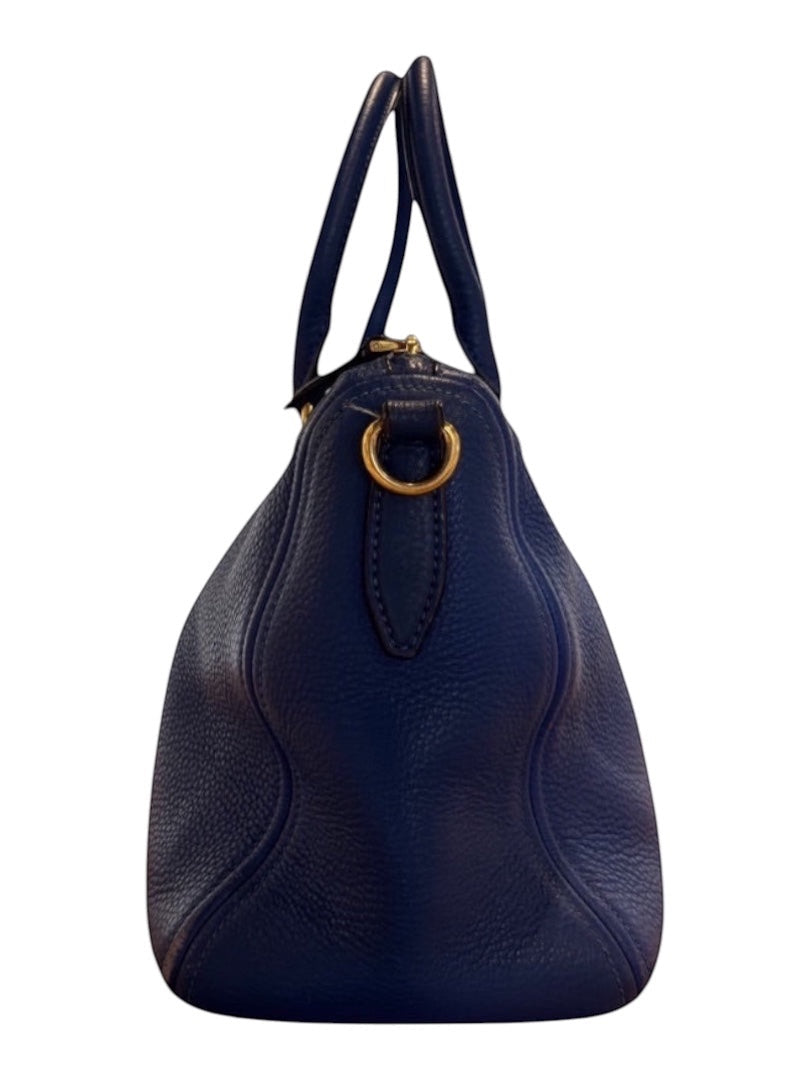 Posh Purse Co. blue Prada Vitello Daino leather handbag with gold hardware and dual handles.
