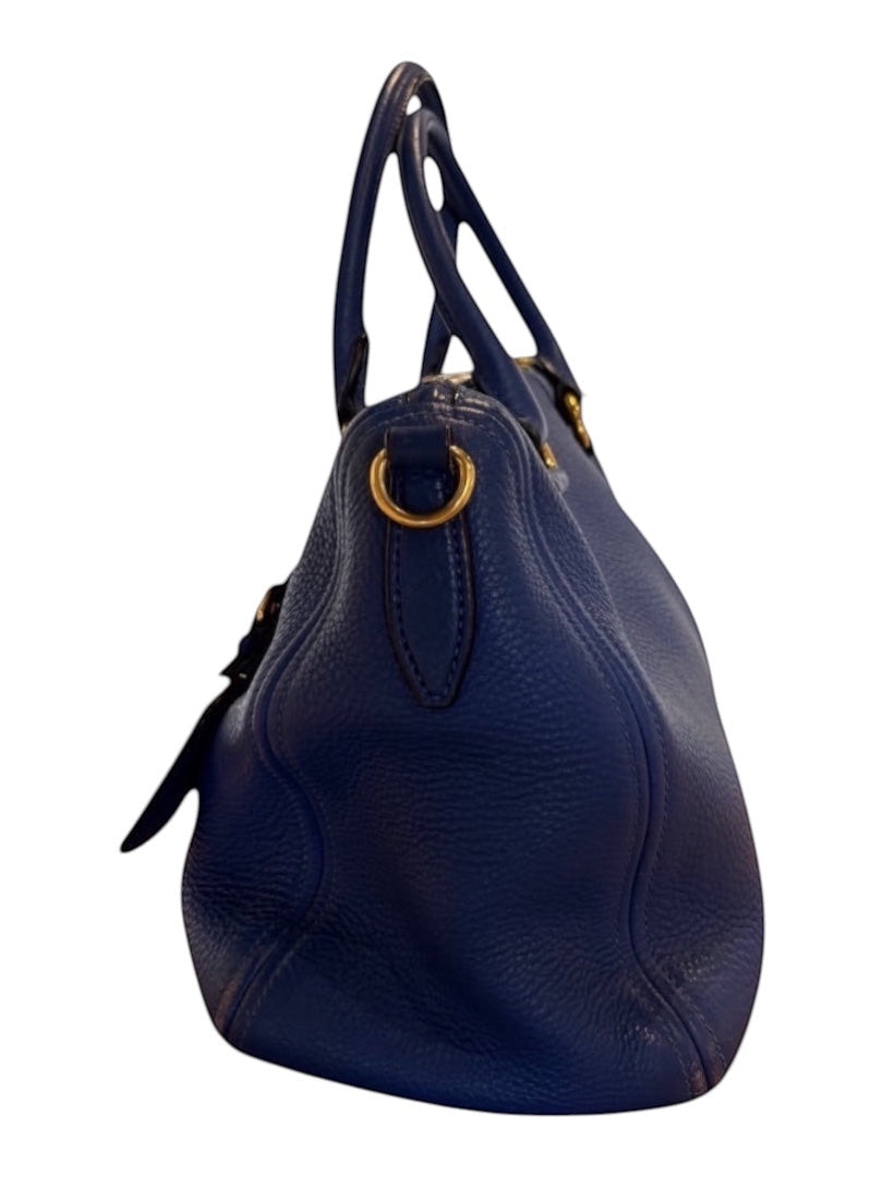 Posh Purse Co. blue Prada Vitello Daino leather handbag with gold hardware and dual handles.