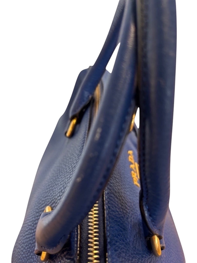 Posh Purse Co. blue Prada Vitello Daino leather handbag with gold hardware and pebbled texture.