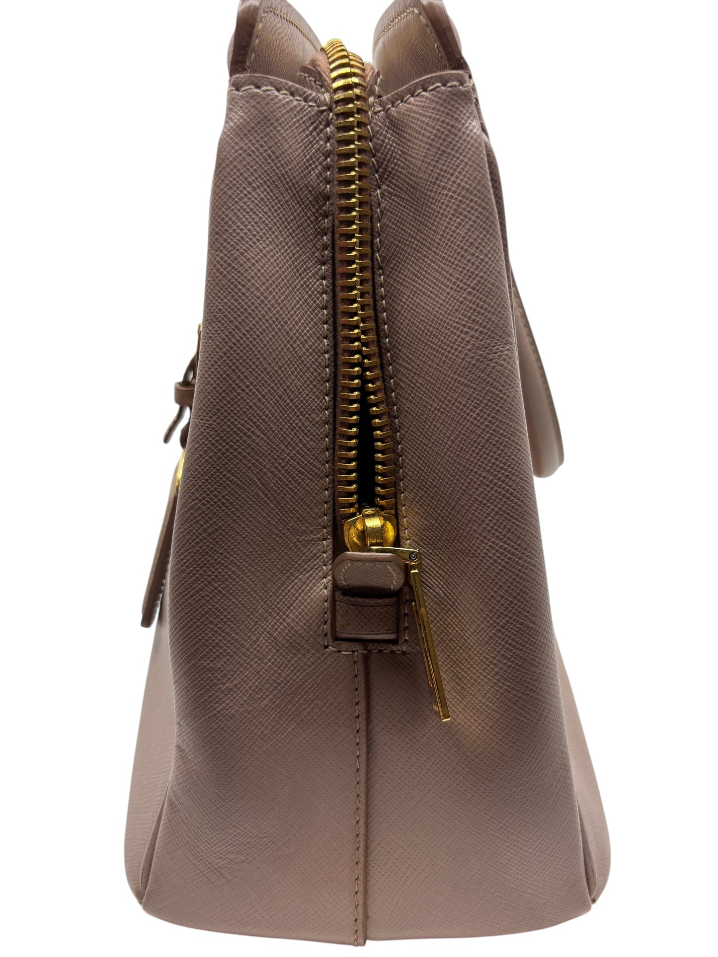 Posh Purse Co. side view of a blush pink Prada Saffiano leather tote bag with gold zipper detail