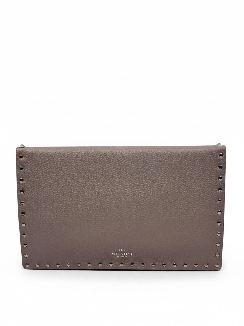 Posh Purse Co blush Valentino Rockstud envelope bag with signature metal stud detailing and pebbled leather texture.