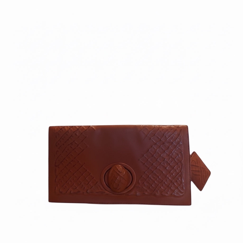 Posh Purse Co brown leather Bottega Veneta turnlock clutch with embossed pattern and gold-tone closure.