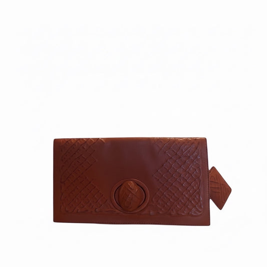 Posh Purse Co brown leather Bottega Veneta turnlock clutch with embossed pattern and gold-tone closure.