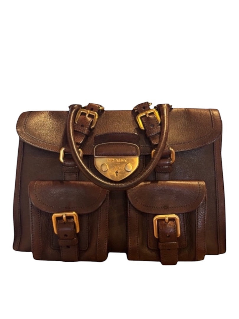 Posh Purse Co Brown Prada Saddle Tote with gold hardware and front buckle pockets.