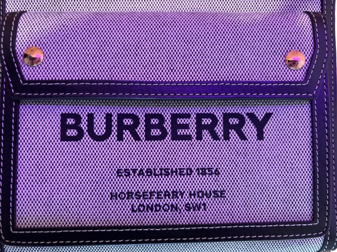 Posh Purse Co. Burberry black and white canvas crossbody bag with front pocket and gold hardware.