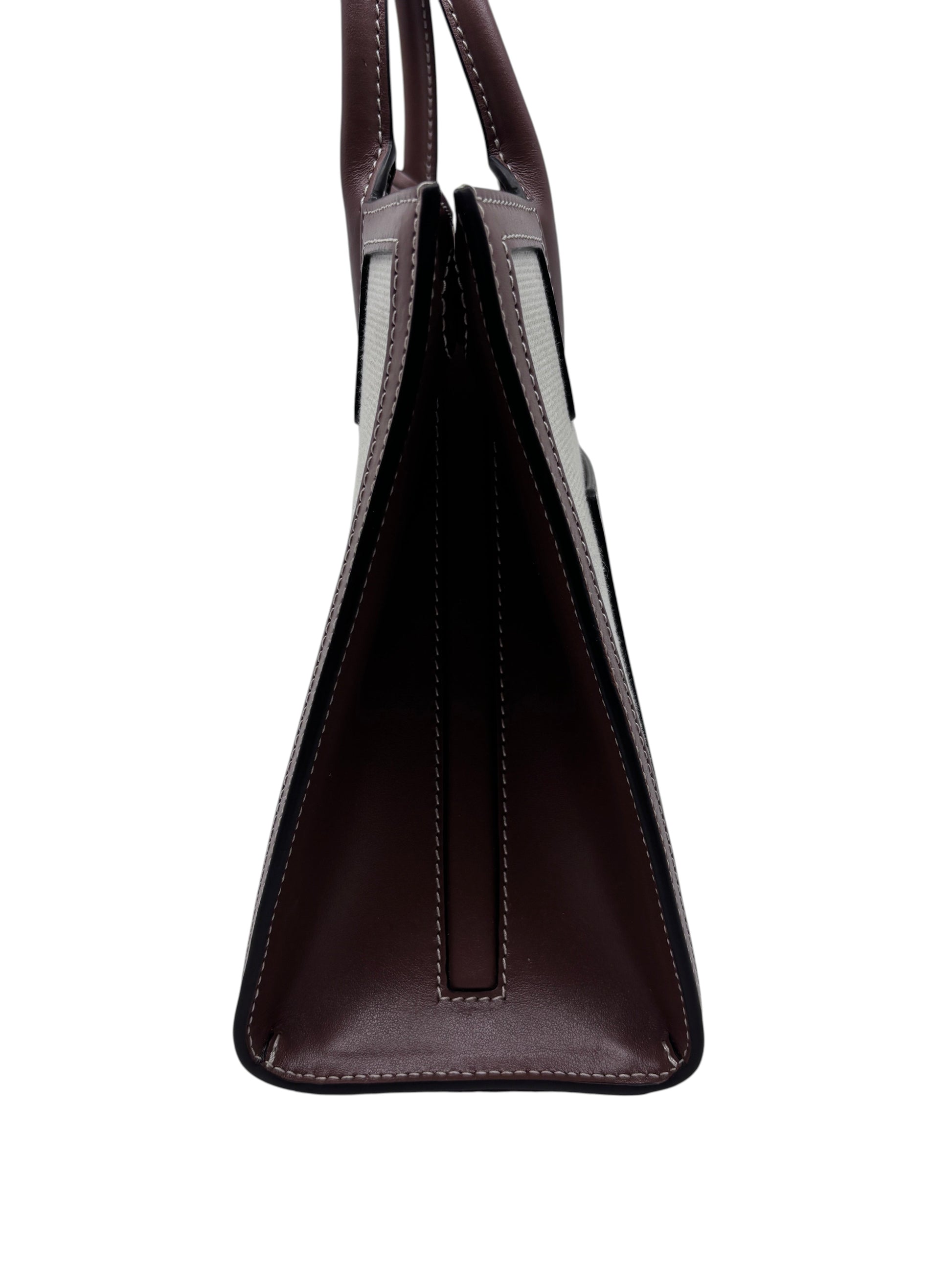 Side profile of a Posh Purse Co Burberry Mini Frances Tote in dark brown leather and canvas with structured design.