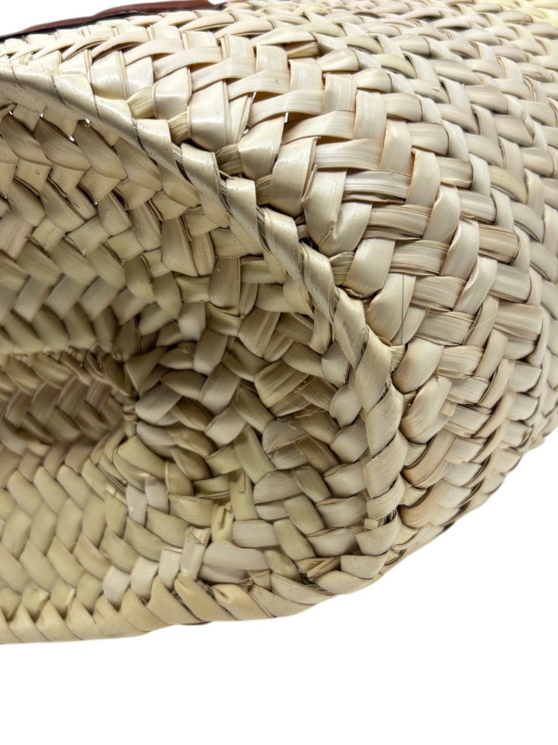 Close-up of the woven natural raffia texture on a Posh Purse Co. Celine Classic Panier bag base.
