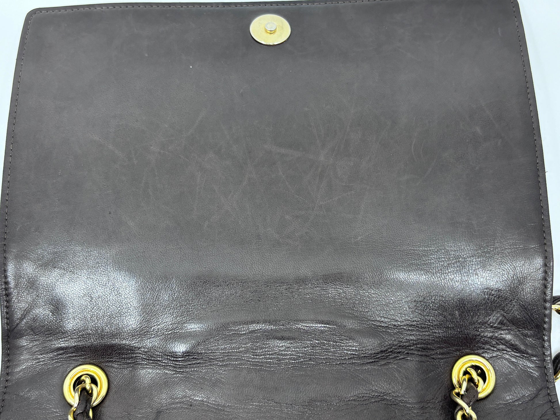 Posh Purse Co preloved brown Chanel Timeless Flap bag interior showing signs of wear and scratches on the leather
