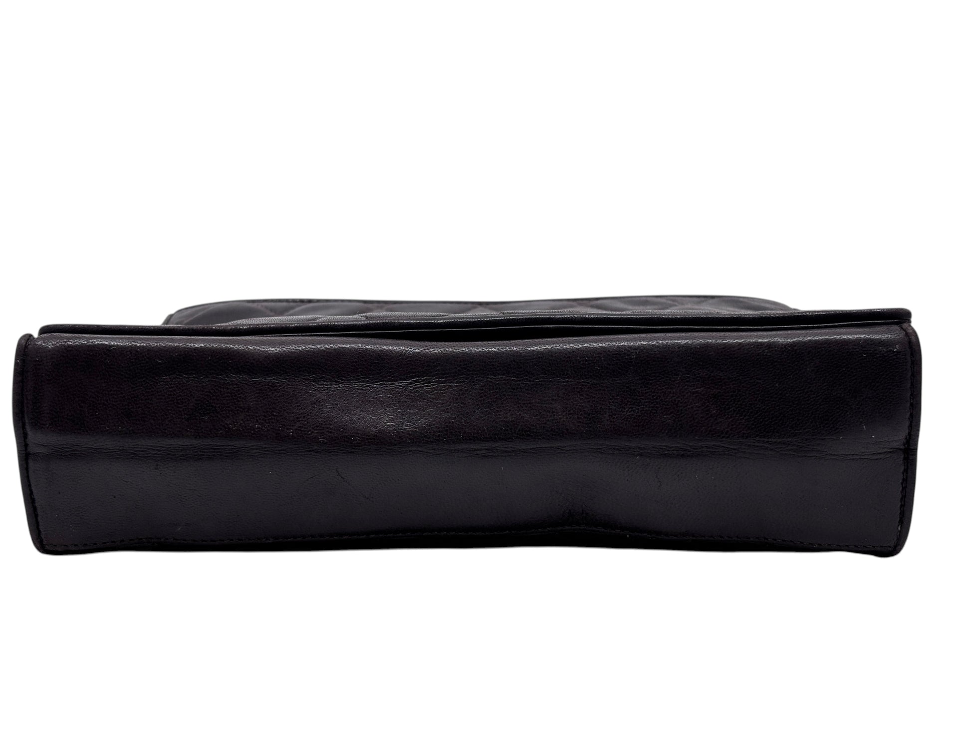 Posh Purse Co brown Chanel quilted Timeless flap crossbody bag viewed from the bottom edge showing leather texture
