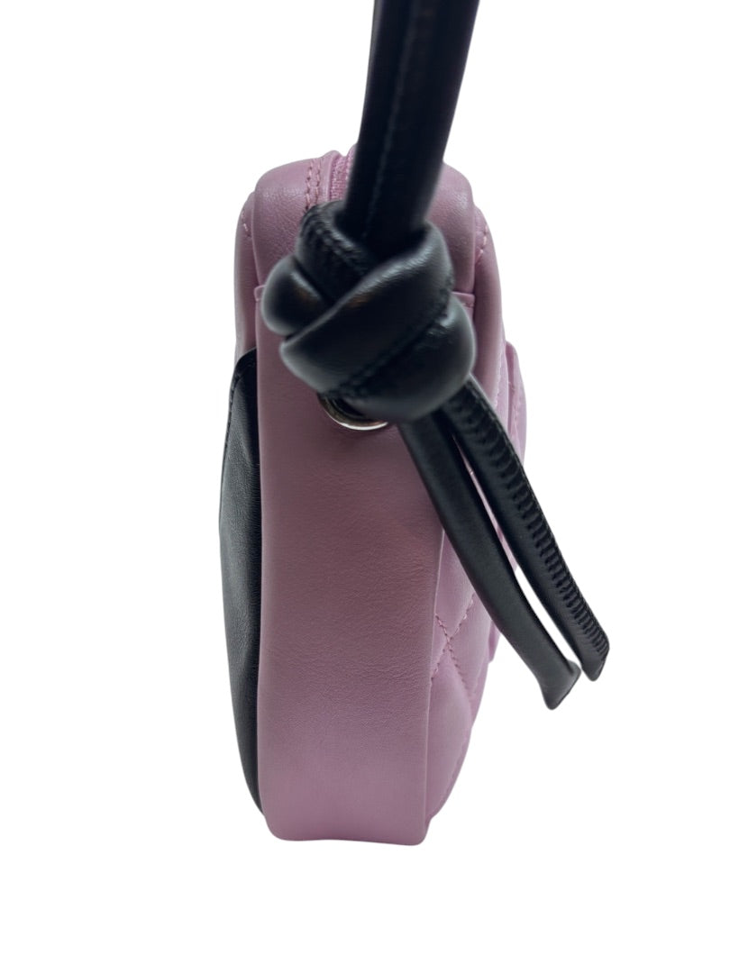Side view of a pink and black Chanel Cambon Ligne bag with a knotted black leather strap from Posh Purse Co