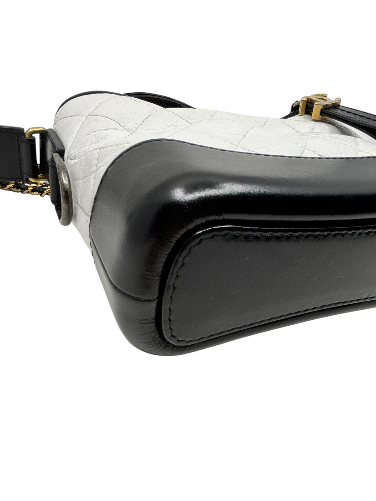 Posh Purse Co Chanel Gabrielle crossbody bag featuring a white quilted leather body and a structured black leather base.