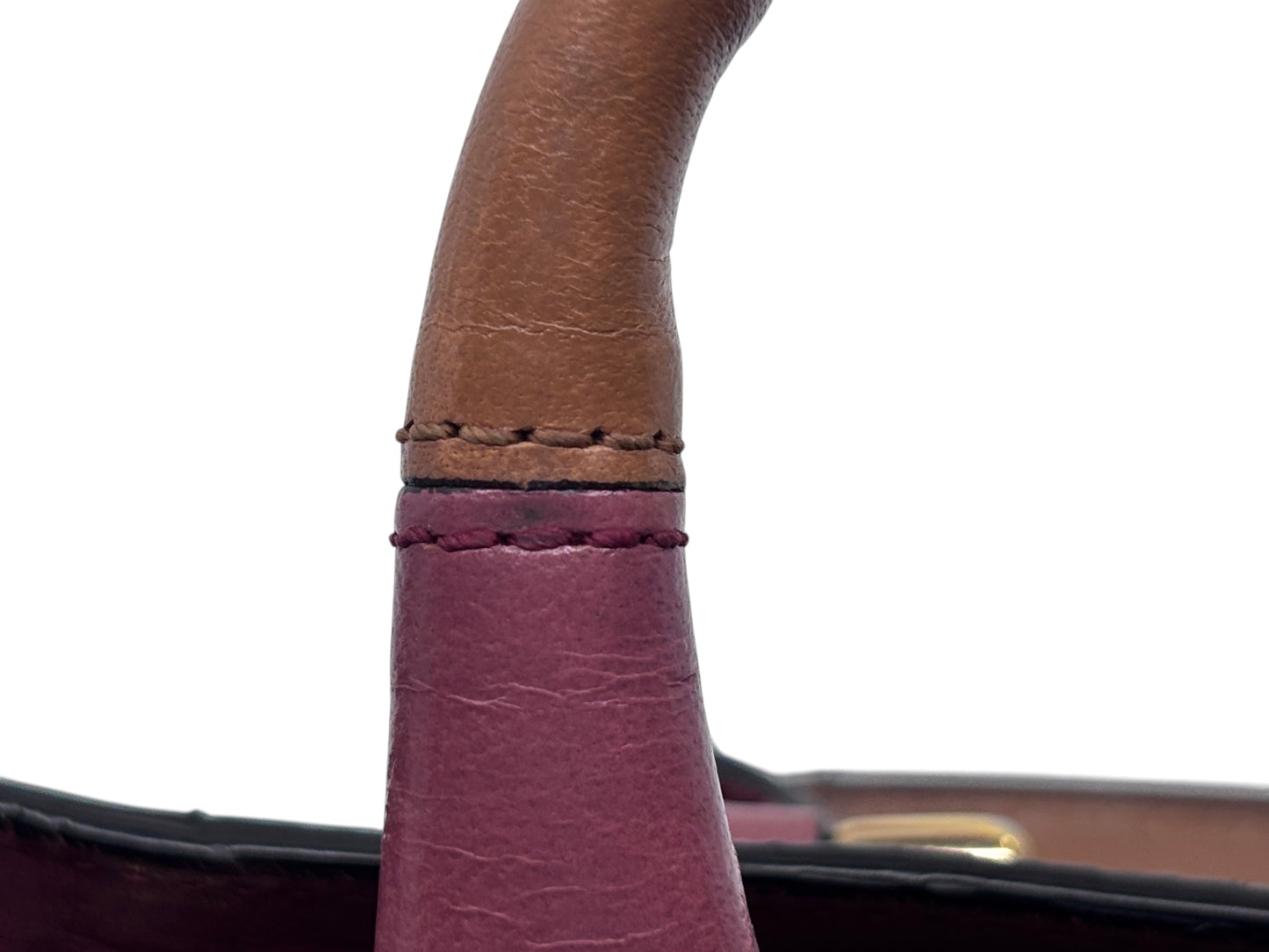 Close-up of the leather handle on a Posh Purse Co. pink Chloé Ethel bag showing contrast stitching and texture.