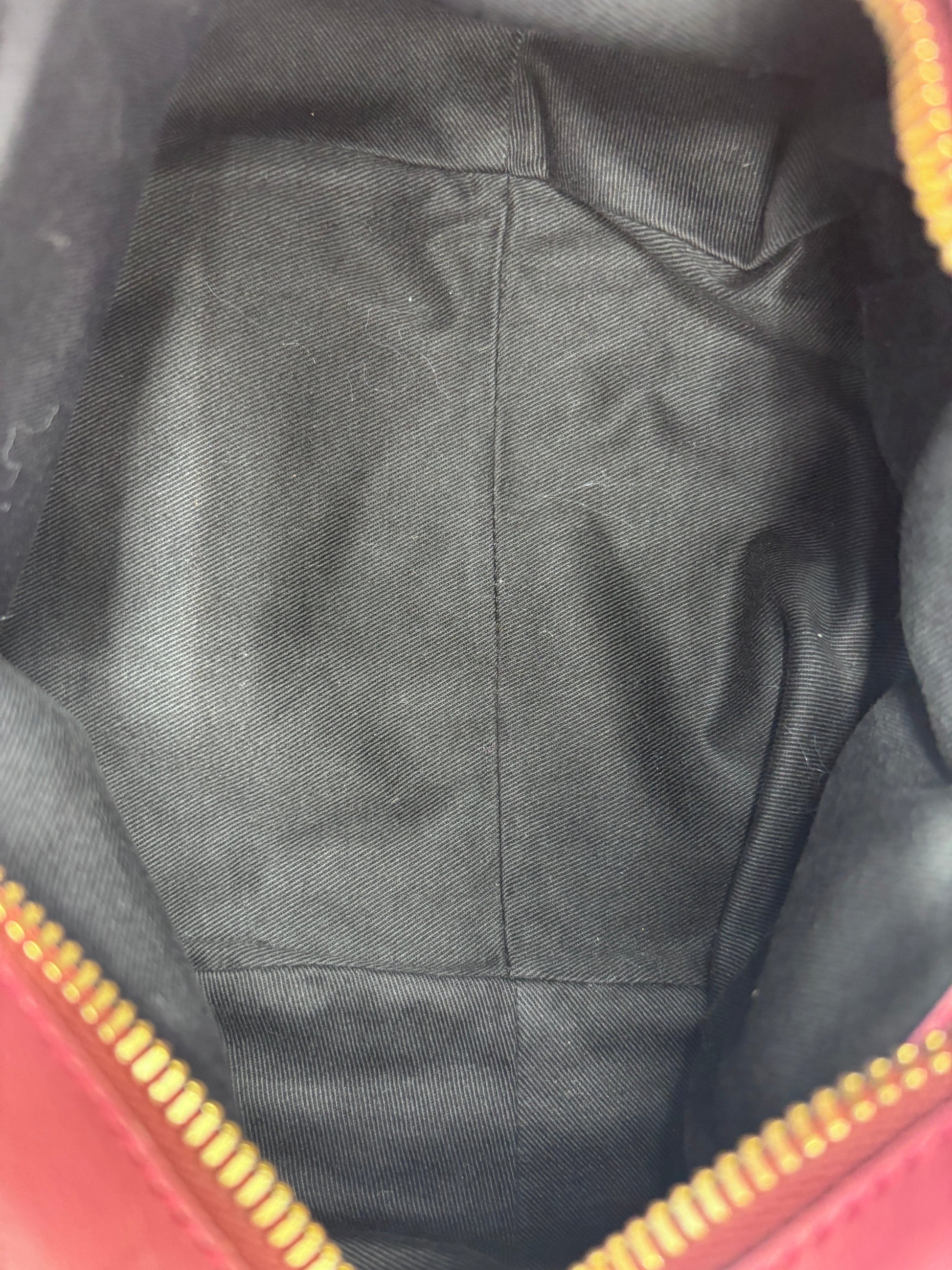 Clean black fabric interior lining of a Posh Purse Co. preloved Chloé Ethel handbag with gold zipper detail