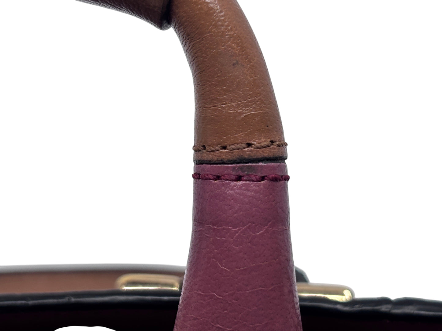 Close-up of the brown leather handle attachment on a pink Posh Purse Co. Chloé Ethel bag showing detailed stitching.