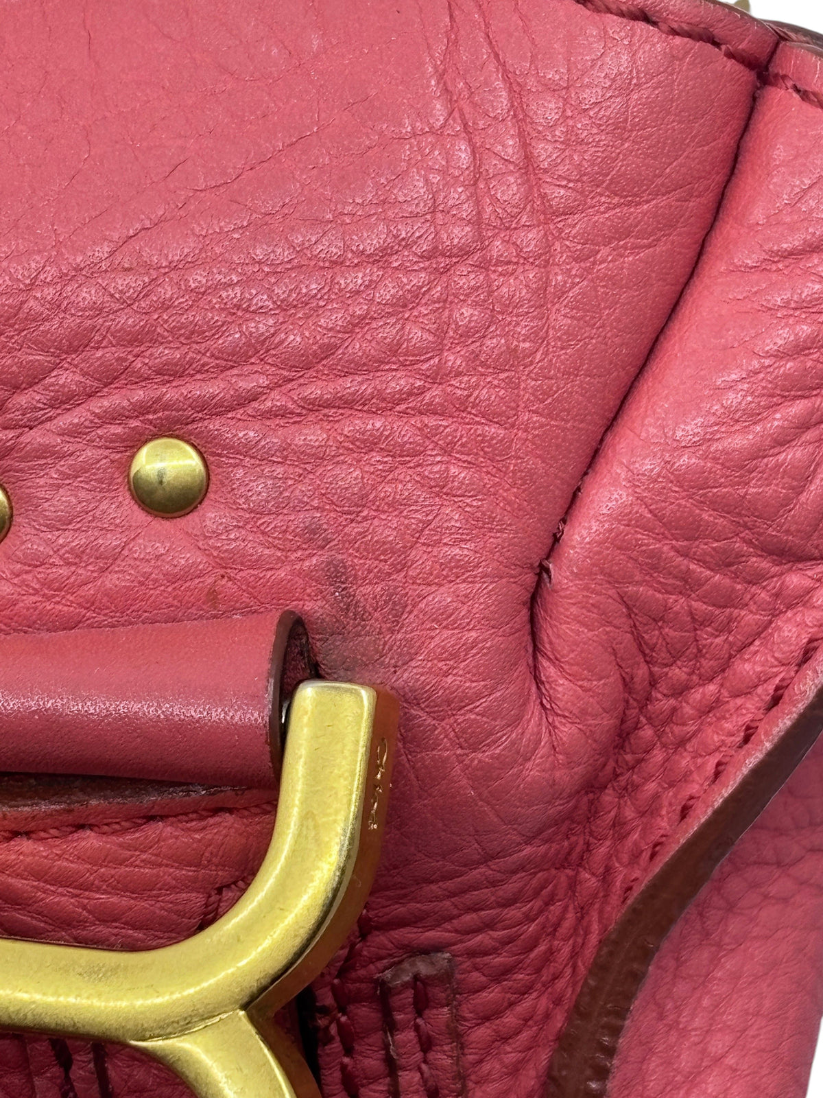 Close-up of Posh Purse Co. preowned Chloé Marcie satchel in coral leather with gold hardware and signature stitching.