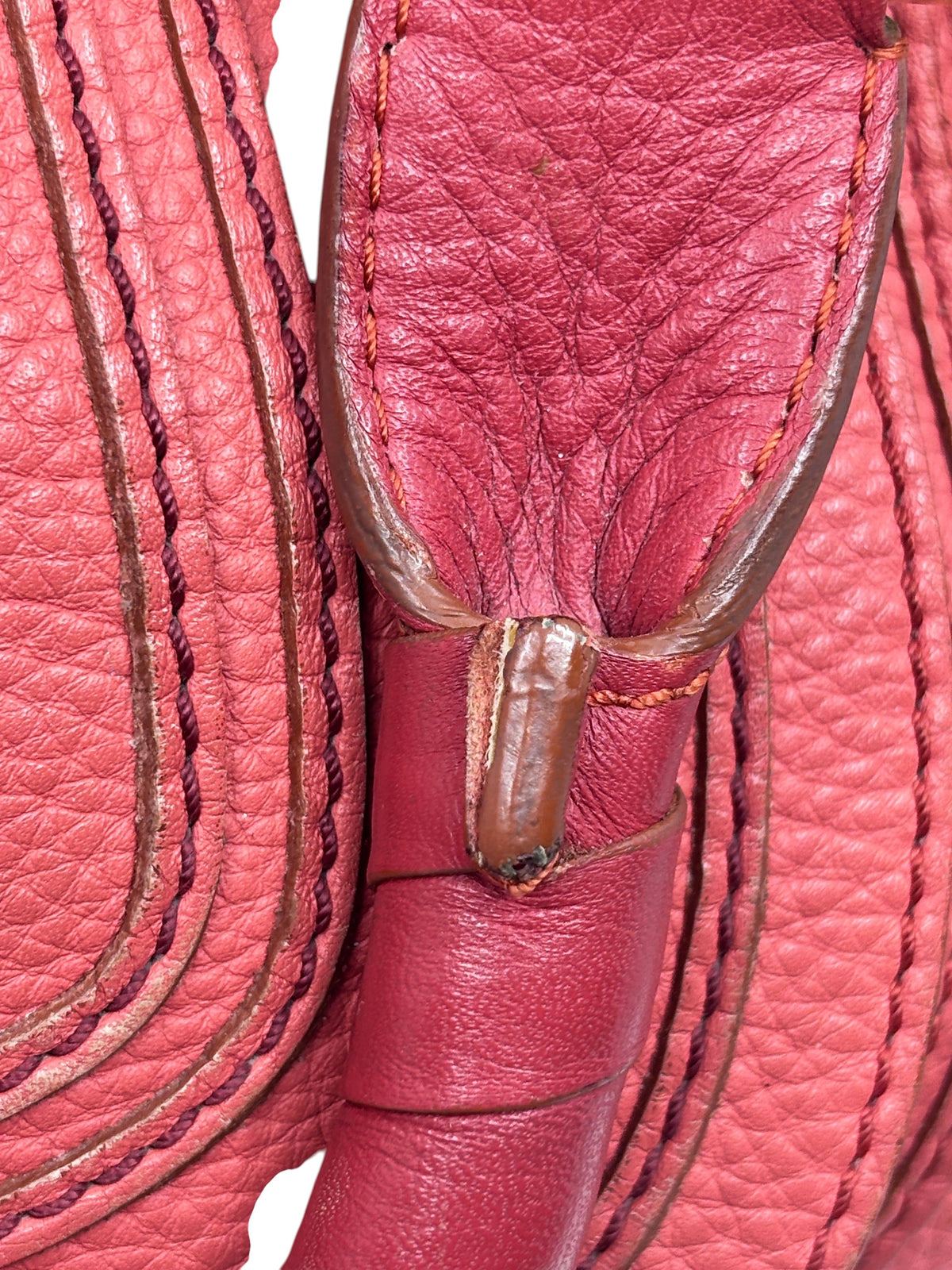 Close-up of Posh Purse Co. preowned Chloé Marcie satchel in coral leather with signature curved stitching and handle