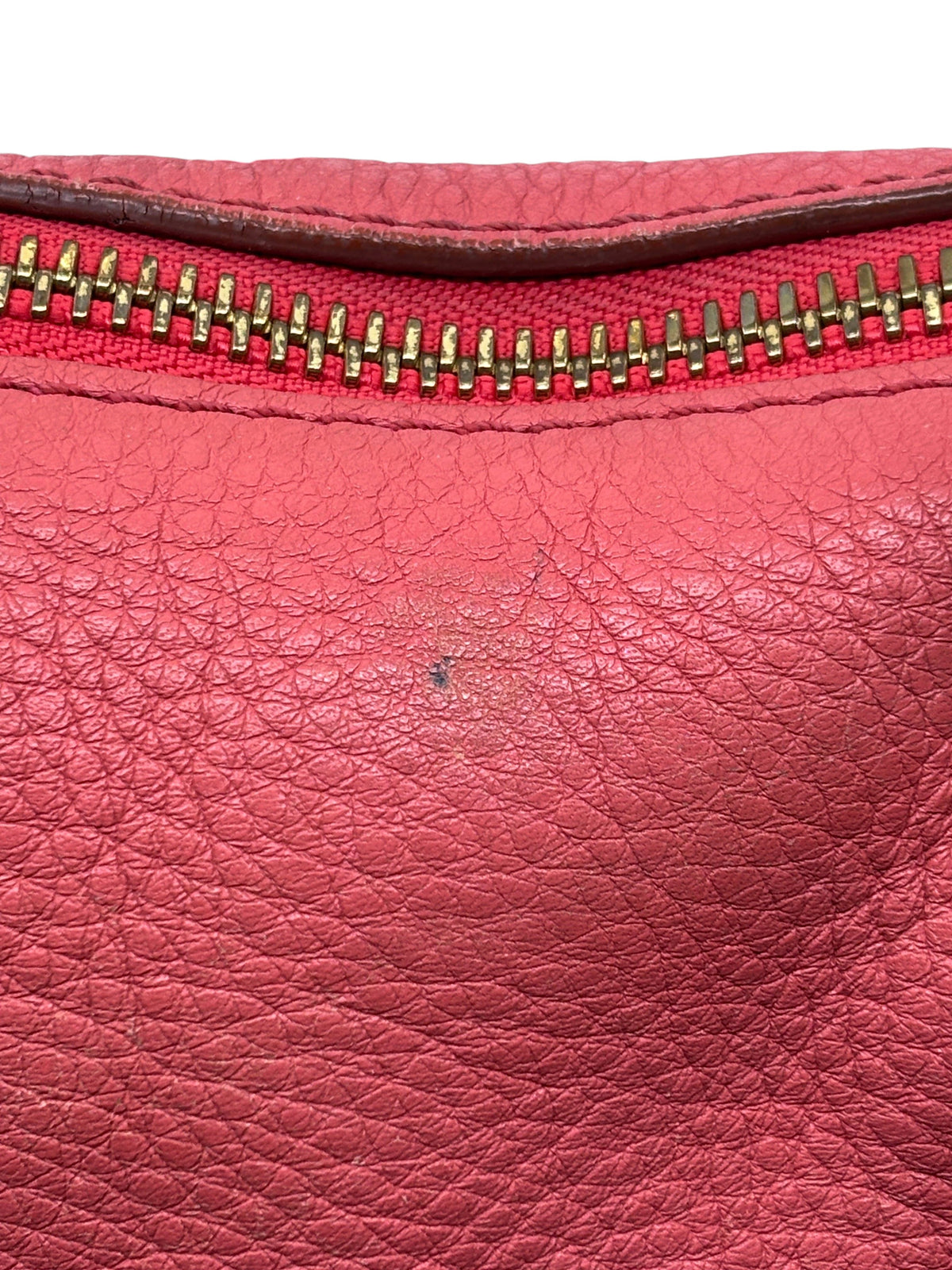 Close-up of Posh Purse Co. preowned coral leather Chloé Marcie satchel showing texture and gold-tone zipper detail.