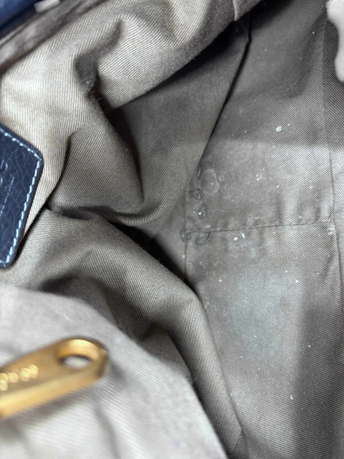 Interior lining of a preloved Posh Purse Co. Chloé Marcie satchel showing fabric texture and signs of use