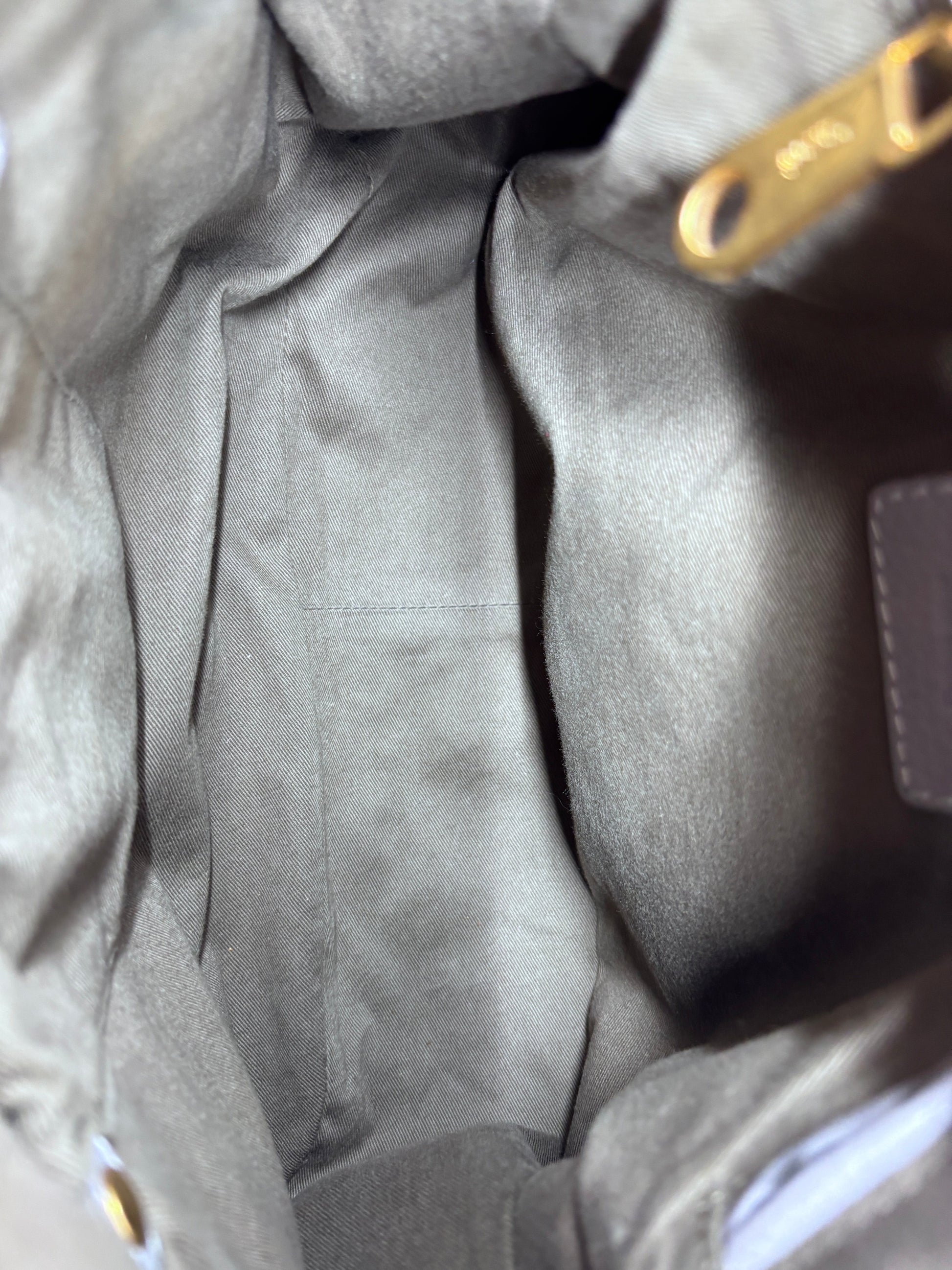 Interior view of the Posh Purse Co preloved gray Chloé Marcie medium satchel bag with fabric lining and gold hardware