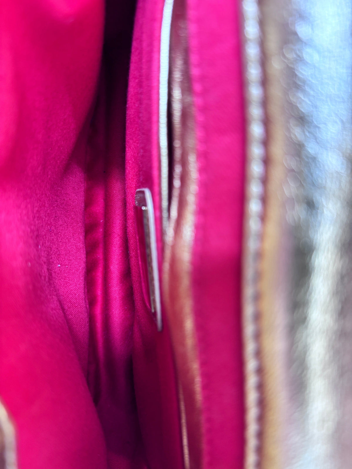 Interior of a Posh Purse Co Christian Louboutin Sweet Charity backpack featuring vibrant pink fabric lining