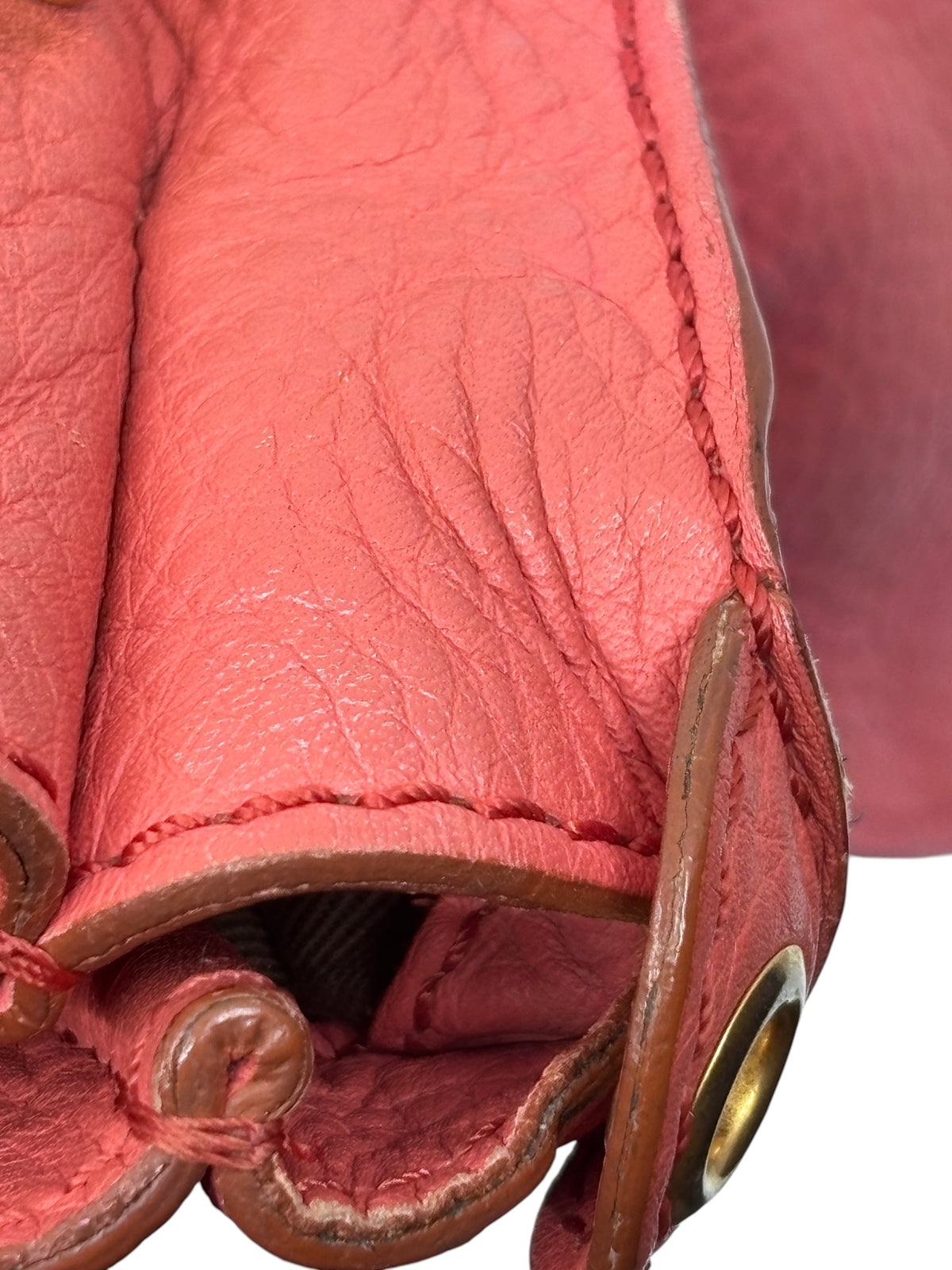 Close-up of Posh Purse Co. preowned Chloé Marcie satchel in coral leather with signature curved stitching and hardware